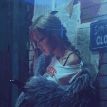 a woman standing in front of a sign that says sunday clock