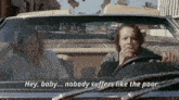 a man and a woman are driving down a street and the man is smoking a cigarette