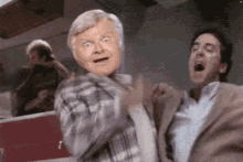 a man in a plaid shirt is making a funny face