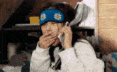 a woman wearing a sleep mask is talking on her phone