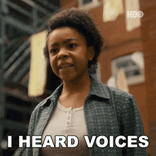 a woman says " i heard voices " in front of a brick building