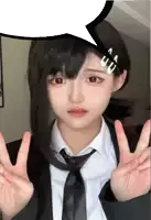 a girl wearing a suit and tie is giving a peace sign