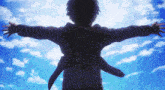 a person with their arms outstretched against a blue sky with clouds