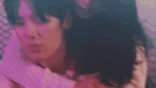a blurry picture of a woman laying on a bed with a man .