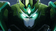 a close up of a green robot 's face with glowing eyes