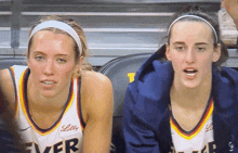 two female basketball players wearing jerseys with lilly written on them