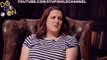 a woman in a striped shirt is sitting in a chair in front of a youtube.com/stupidoldchannel logo