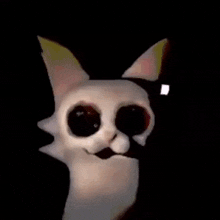 a white cat with big black eyes is standing in the dark and smiling .