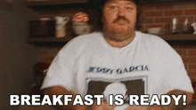 a man wearing a t-shirt that says eddy garcia says breakfast is ready