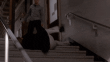 a man is falling down a set of stairs with a handrail