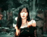 a woman with long hair wearing a black top and a necklace
