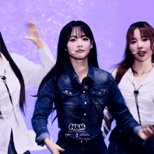 a girl wearing a denim shirt that says n3m on it