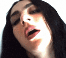 a close up of a woman making a funny face with her mouth open
