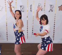 two women are dancing in front of a sign that says ria