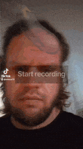 a man with a bird on his head and the words start recording