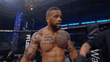 a man in a boxing ring has a tattoo on his chest that says " ever wrestling "