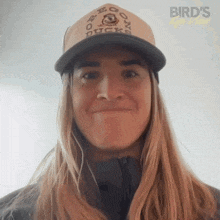a woman wearing a hat that says bird 's