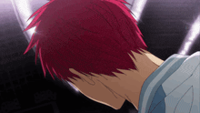 a man with red hair looks down at something