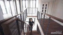 a woman is walking down a set of stairs that are made in animatica