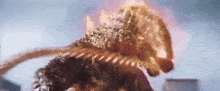 a close up of a monster with flames coming out of its mouth and a city in the background .