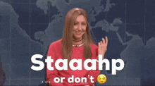 a woman in a red sweater says staaahp or don 't in front of a map of the world