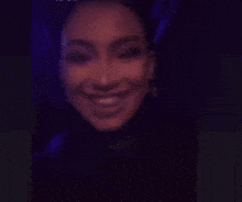 a close up of a person 's face in a dark room .