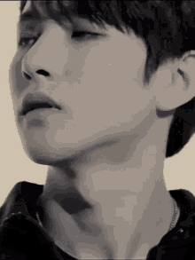 a black and white photo of a man 's face