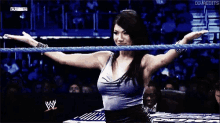 a woman is standing in a wrestling ring with her arms outstretched and the word diva edits on the bottom