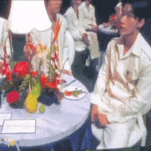 a group of people are sitting around a table with a sign that says ' dinner ' on it