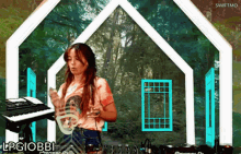 a woman playing a keyboard in front of a house that says lpgiobb1
