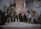 a group of men are looking at a carpet