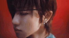 a close up of a person 's face wearing earrings