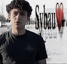 a young man wearing a grey hurley t-shirt