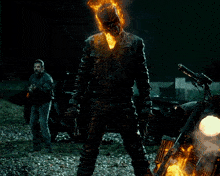 a ghost rider with flames coming out of his face is holding a gun