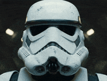a close up of a storm trooper helmet with a black stripe