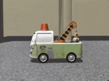 a toy tow truck with a crane on the back