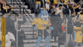 a mascot for the nashville flyers stands in front of a crowd