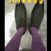 a person wearing purple socks and black shoes with smiley faces on them
