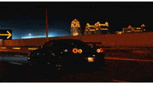 a black car is driving down a highway at night with the words morris mekanik written above it