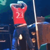 a man in a red jersey with the number 23 on it