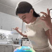 a woman in a kitchen with the word zeudigifs on the bottom left