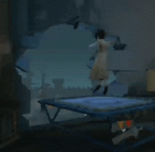 a woman is jumping on a trampoline in a dark room