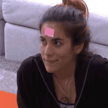 a woman has a pink sticky note on her forehead that says ' i love you '
