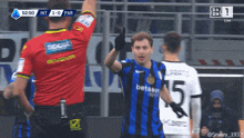 a soccer player wearing a betano jersey is giving a high five
