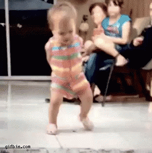 A baby dancing off to a beat