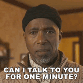 a man wearing a hat and sweater is asking if he can talk to you for one minute
