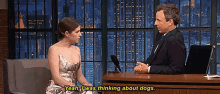 a woman in a silver dress is talking to a man in a suit who says yeah