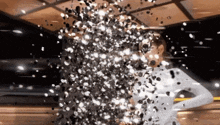 a woman in a white dress is surrounded by confetti falling around her