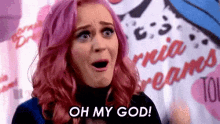 a woman with pink hair is making a face and saying oh my god .