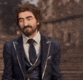 a man in a suit and tie is pointing at something in the distance .